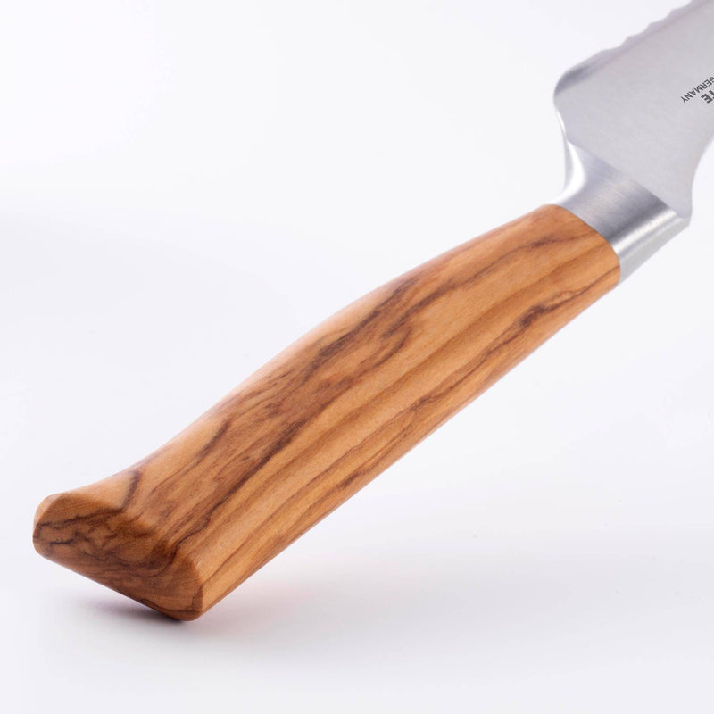 Close-up of Messermeister Oliva Elite Scalloped Offset Knife handle, showcasing its ergonomic olive wood grip and stainless-steel bolster for precise bread slicing.