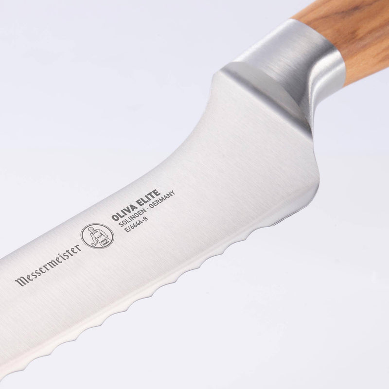 Close-up of Messermeister Oliva Elite Scalloped Offset Knife, showcasing the serrated stainless-steel blade and ergonomic olive wood handle, perfect for slicing bread effortlessly.