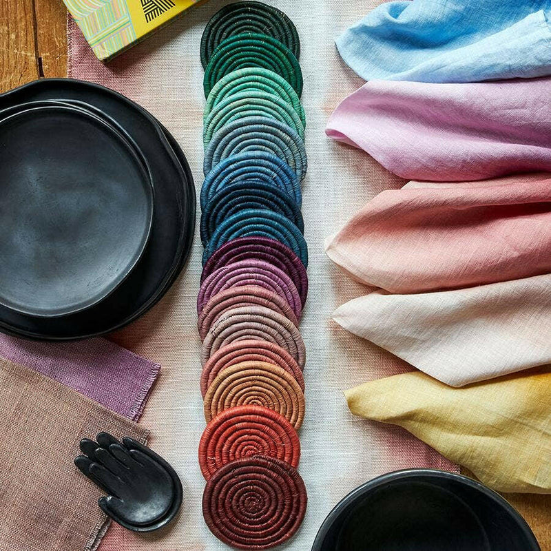 St. Frank | Ombré Coaster Collection - Blue: A close-up of woven coasters tied with a black grosgrain ribbon, showcasing intricate craftsmanship with natural fibers.