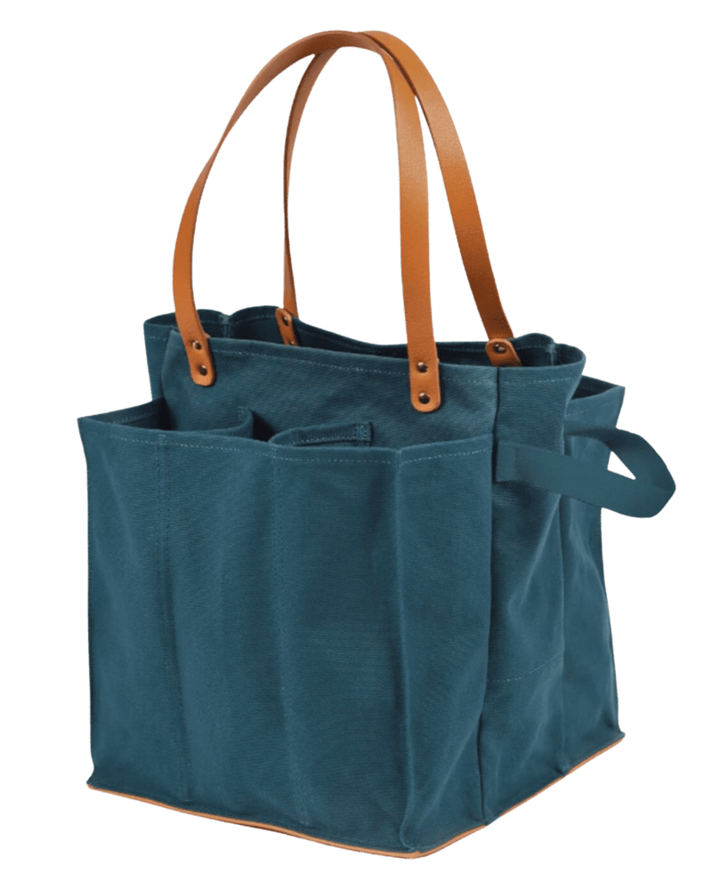 CapaBunga Market Tote features sturdy design with brown handles, compartments for fragile items, and external cinching straps, ideal for market or outdoor use.
