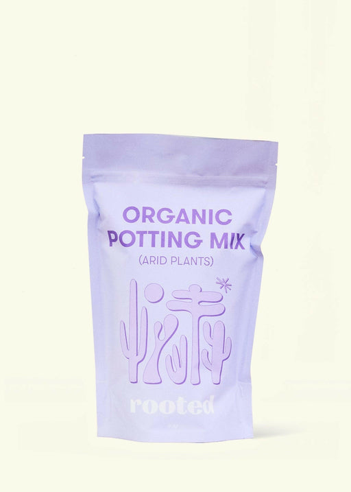 Rooted | Organic Potting Mix - Arid: Stand-up pouch featuring desert plant silhouettes, designed for cacti and succulents with organic compost and nutrient-rich ingredients.