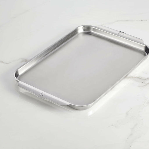 Hestan Provisions | OvenBond Tri-Ply Bakeware - Medium Rack Only, showcasing a durable stainless-steel baking sheet with low sides and curved handles on a light countertop.