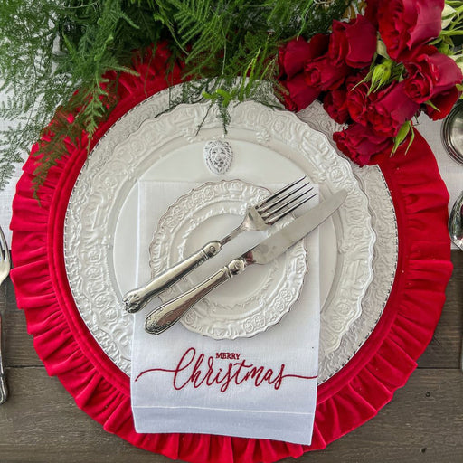 Round Ruffle 16.5 Inches placemat elegantly sets a festive table with ornate plates, silverware on a napkin, and a floral centerpiece.