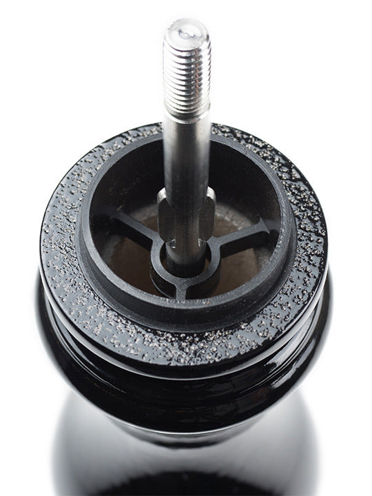 Peugeot | Paris u'Select Pepper Mill, Black Lacquer Wood, 9 inches, showcasing the top metal spindle and grinding burr with stray pepper granules visible.