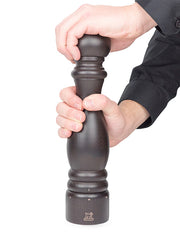 Peugeot | Paris u'Select Wood Pepper Mill Chocolate, 12 inches, shown in use with hands demonstrating its ergonomic design and grinding adjustment system.