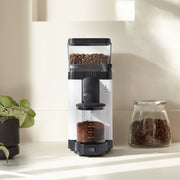 Moccamaster KM5 Burr Grinder in Matte Black and Polished Silver, featuring a direct-drive motor, static-reducing spout, and stepless adjustment for precise coffee grinding.