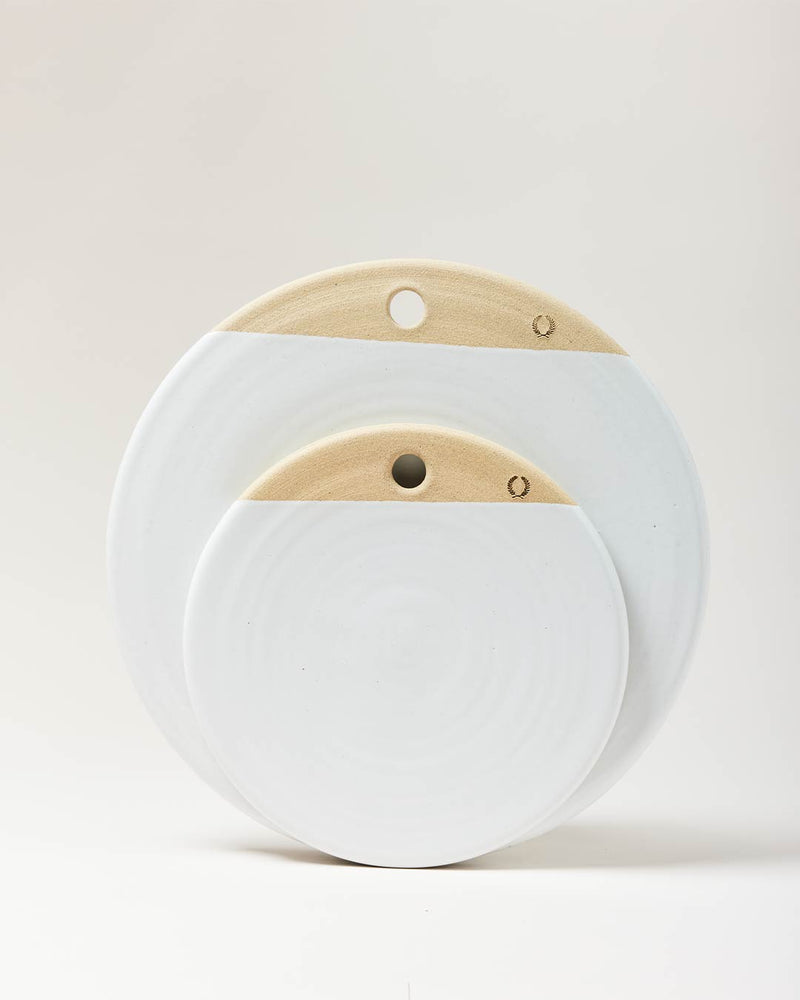 Farmhouse Pottery | Cheese Stone (14-Inch) showcases two nested, round serving boards with natural clay tops and white glazed bottoms, perfect for cheese or charcuterie.