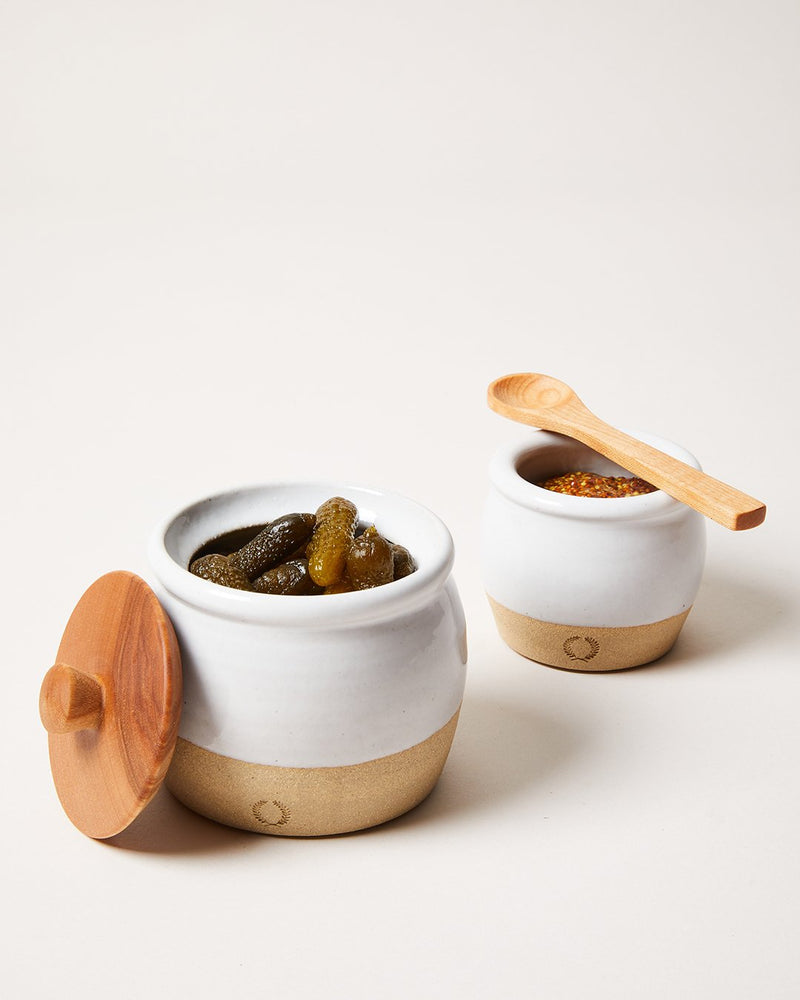 Farmhouse Pottery | Pickle Pot - with Spoon: Two stoneware crocks, one with pickled gherkins, the other with grainy mustard, featuring a wooden spoon.