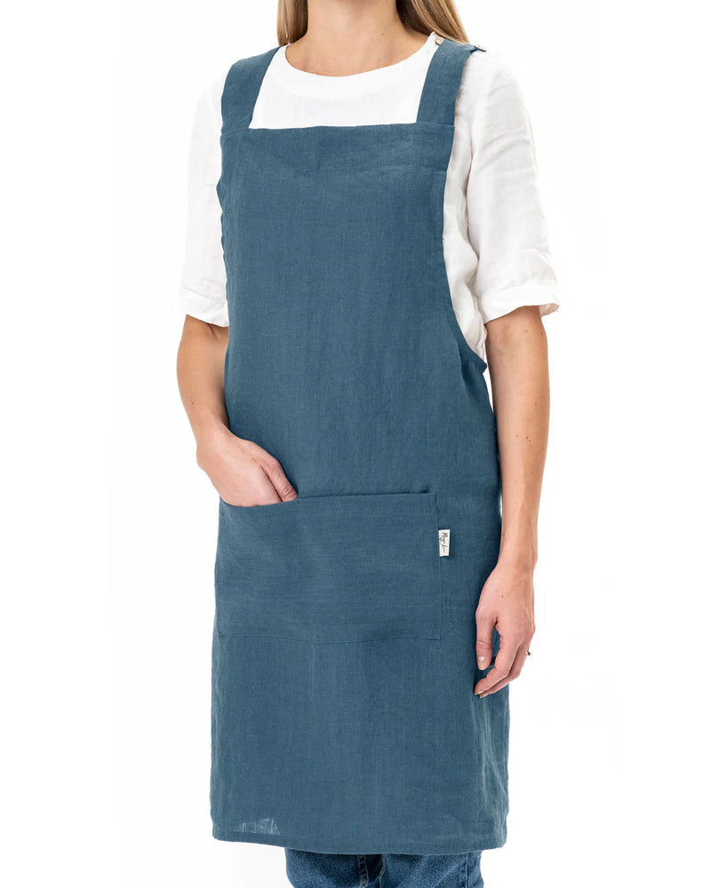MagicLinen Pinafore Cross-Back Linen Apron in Dusty Blue, L-XL, featuring criss-cross straps and side pockets, ideal for cooking and gardening enthusiasts.