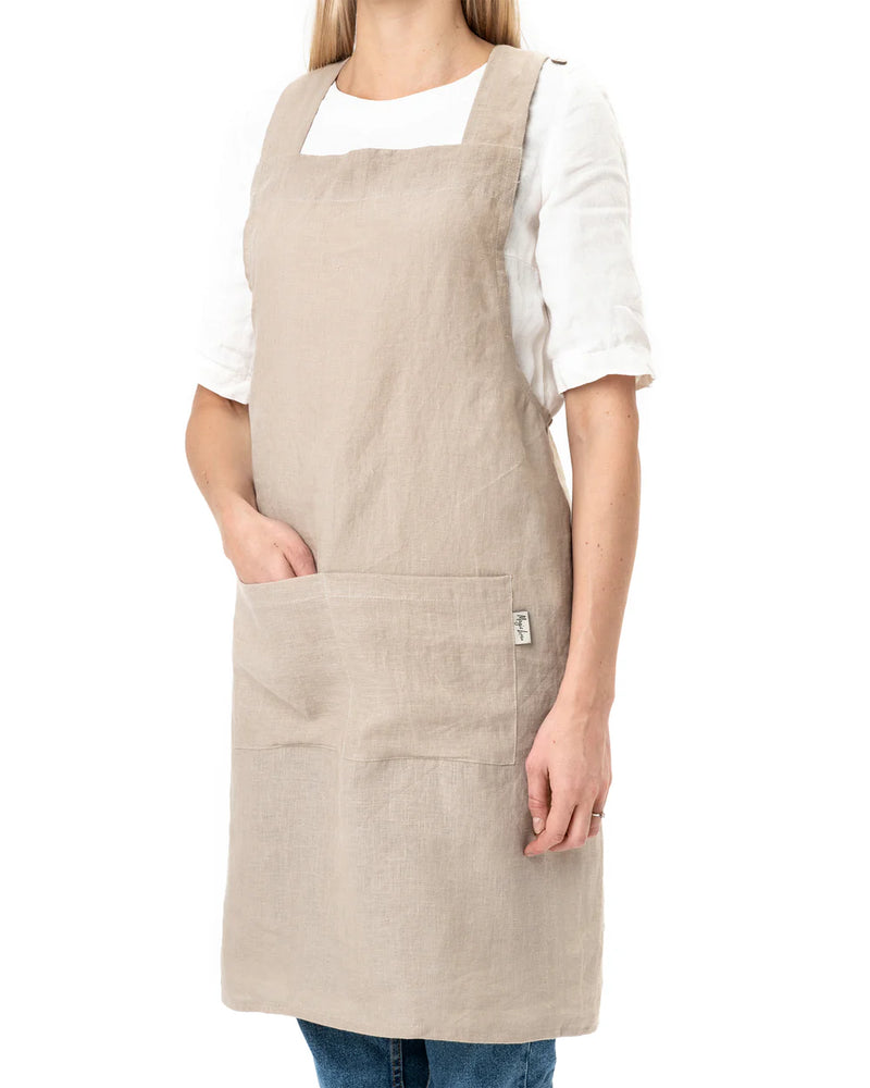 MagicLinen Pinafore Cross-Back Linen Apron in L-XL, featuring a stylish design with criss-cross straps and side pockets, perfect for cooking or gardening.
