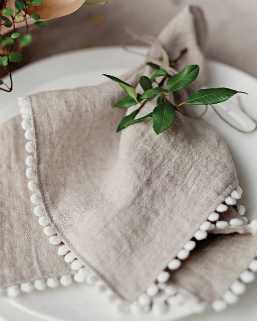 MagicLinen | Pom Pom Trim Linen Napkins - Natural Linen - Set of 2, featuring elegant white pom pom trim, perfect for enhancing dining decor.