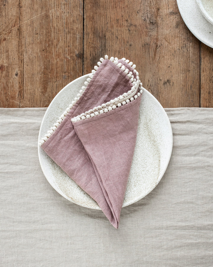 MagicLinen Pom Pom Trim Linen Napkins, set of two, showcasing elegant design and craftsmanship, perfect for enhancing any dining table setup.