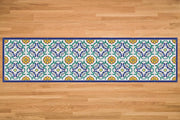 Etú HOME | Positano B Italian Vinyl Rug on wood floor, showcasing intricate blue, green, yellow, and white patterns, ideal for kitchens and entryways.