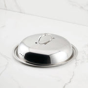 Hestan Provisions | Stainless Steel Lids Dome, 14 with ergonomic handle on a matching tray, ideal for maintaining heat and flavor in culinary settings.