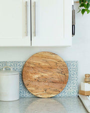 Peterman's Boards and Bowls 20 Lazy Susan - Spalted, handcrafted for smooth, wobble-free rotation, displayed on a kitchen counter with a white container and wooden elements.