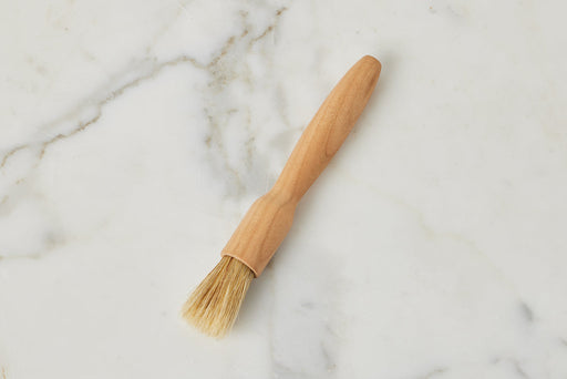 Etú HOME | Cherrywood French Pastry Brush with light natural bristles and a smooth handle, ideal for precise baking applications, on a marble surface.