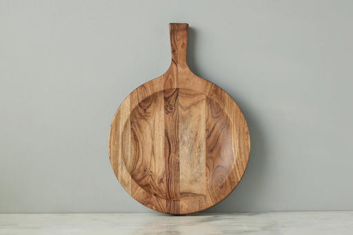 Large etúHOME Italian Cutting Board Bowl displayed on a countertop, showcasing its smooth, round wood surface and short handle, ideal for kitchen use.