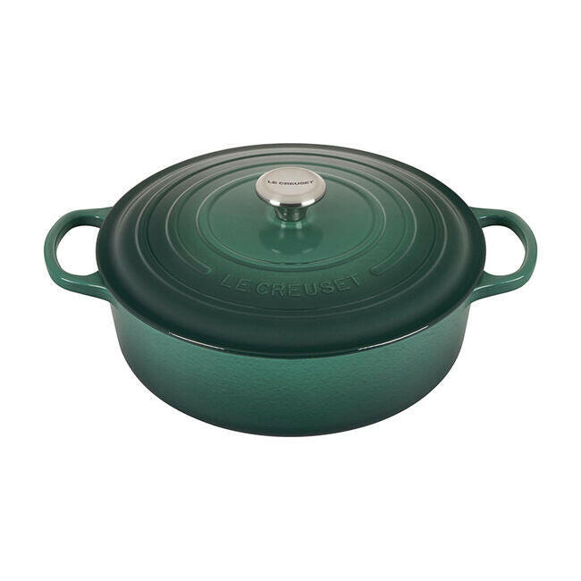 Le Creuset Signature Round Wide Oven in Olive, a 6.75-quart enameled cast-iron casserole with a metal knob and dual side handles, ideal for versatile cooking.