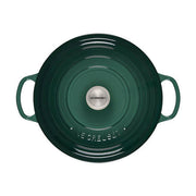 Le Creuset Signature Round Wide Oven in forest-green, 6.75-quart capacity, with side handles and domed lid, perfect for even cooking and elegant table presentation.