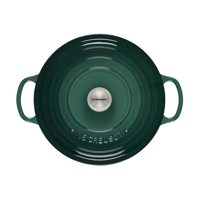Le Creuset Signature Round Wide Oven in forest-green, 6.75-quart capacity, with side handles and domed lid, perfect for even cooking and elegant table presentation.