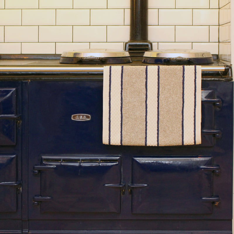 Blue stove with an Earth & Nest | Blue Range Towel draped over; part of kitchenware collection from Athens Cooks, specializing in curated cookware and accessories.