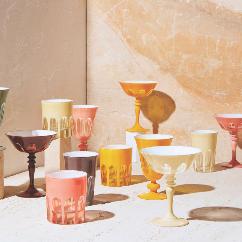 Sir|Madam Rialto glassware collection lifestyle shot with Ox Blood coupe on a marble backdrop