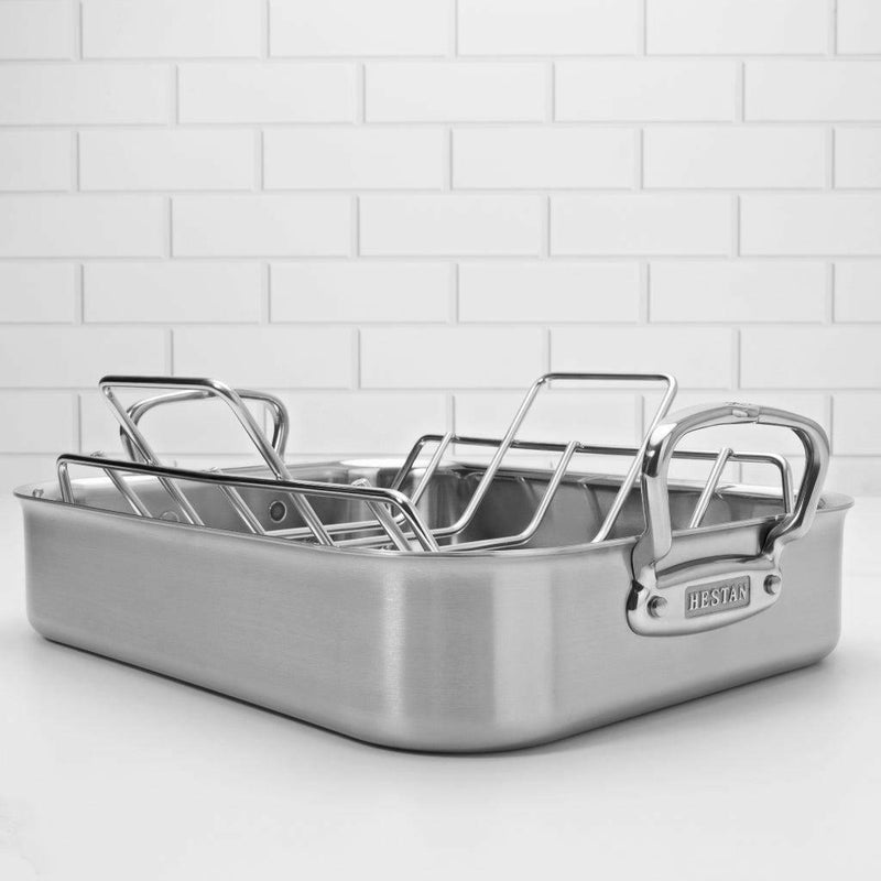 Hestan Provisions | Classic Roaster with Rack - 16.5 Inch, stainless-steel roasting pan with removable wire rack, ideal for versatile cooking, shown on a light countertop.
