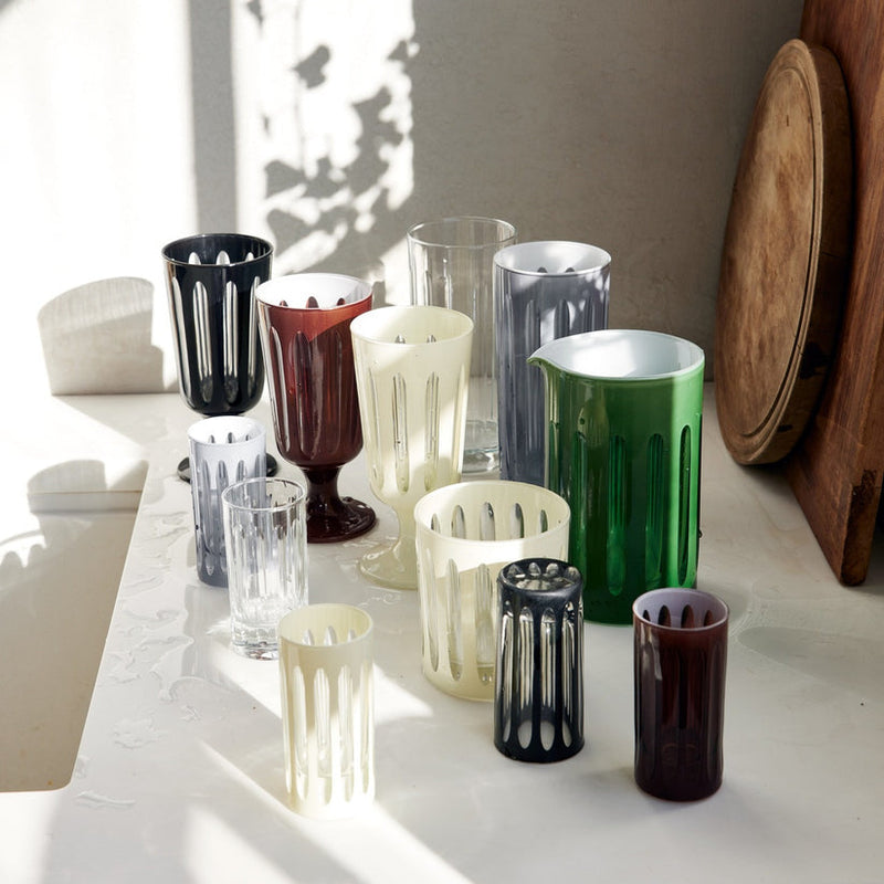 Sir|Madam Empire Powder Highball Glasses, Set of 2, air-drying on countertop, showcasing unique vertical lines and intricate cutwork, inspired by 1920s skyscrapers.