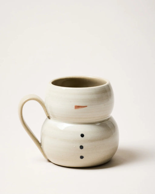 Farmhouse Pottery | Collector's Edition Snowman Mug features a hand-thrown ceramic design with snowman-like sections, a painted nose, and button details, embodying Athens Cooks' curated kitchen charm.