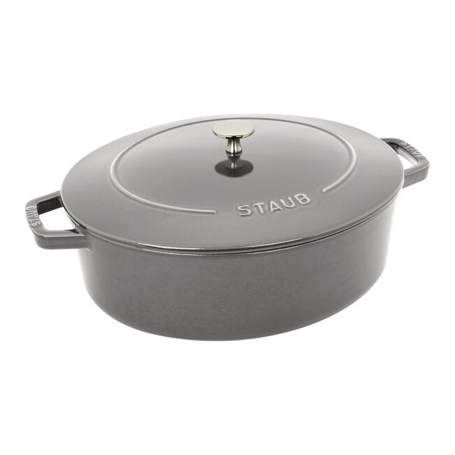 Staub | Wide Oval Dutch Oven - Graphite Grey, featuring a brass knob lid, ideal for braising and baking, offering 20% more cooking surface for versatile culinary use.