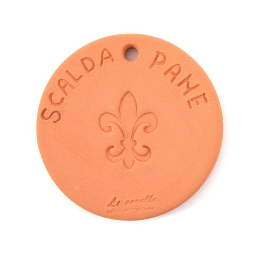 Close-up of the UASHMAMA Scaldapane bread warmer, a round terracotta plate with a fleur-de-lis engraving, designed to keep bread warm in tabletop bags.