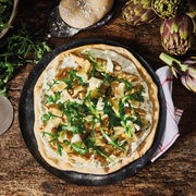 de Buyer Blue Steel Pizza Tray - 16 in, showcasing its perforated design for crispy crusts and even heat distribution, ideal for pizzas and tarts.