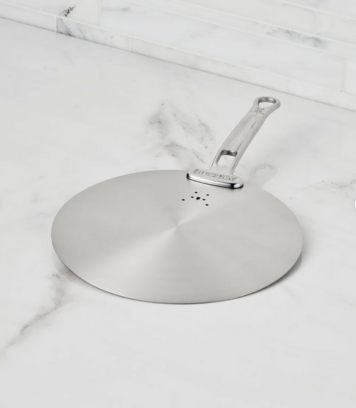 Hestan | Provisions Stainless Steel Universal Lids, Medium, on marble countertop, features steam vents and handle, ideal for skillets, enhancing kitchen organization and efficiency.