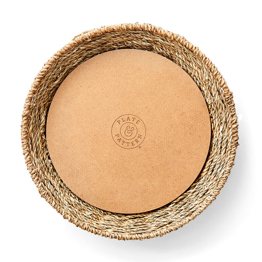 Seagrass plate with wood bottom board, showcasing a close-up of the Plate & Pattern logo, ideal for adding texture to dining décor.