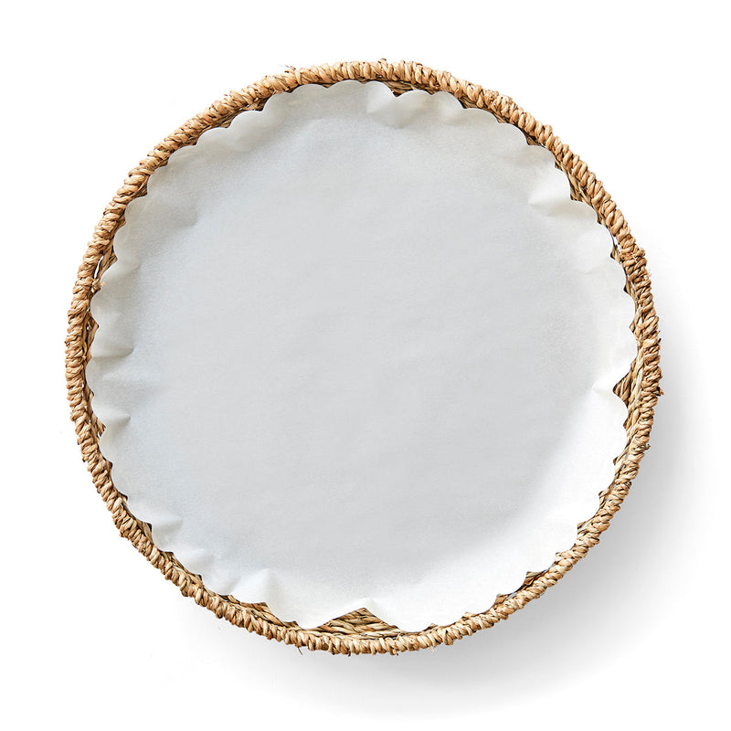Woven Seagrass Plates - Set of Four with Liners, featuring a wicker basket with white liners, ideal for stylish table settings.