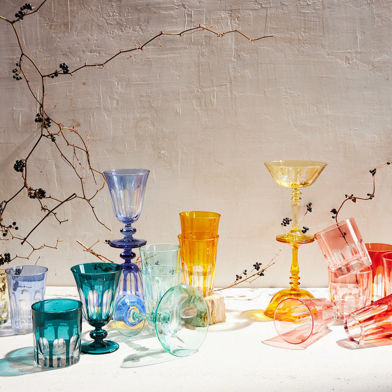 Sir|Madam Rialto Old Fashion set of 2 in light red, artfully arranged among twisting branches, showcasing handcrafted glassware inspired by Venetian arches.