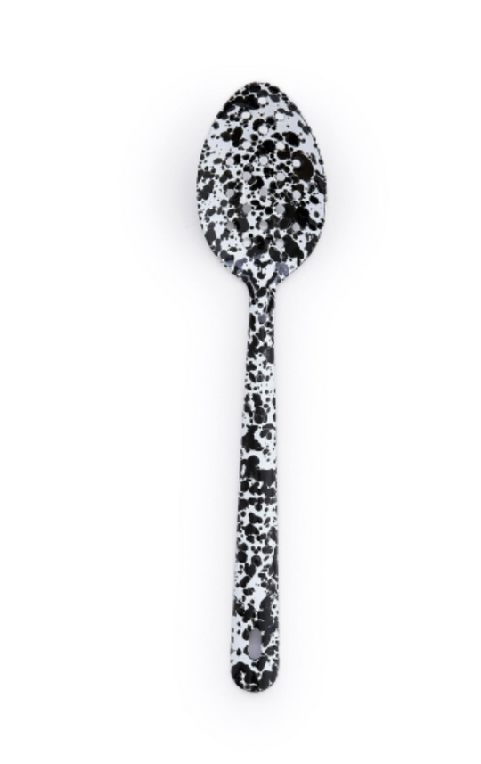 Crow Canyon Home Splatter Enamelware Large Slotted Spoon in black splatter pattern, showcasing its durable, stylish design ideal for both indoor and outdoor dining.