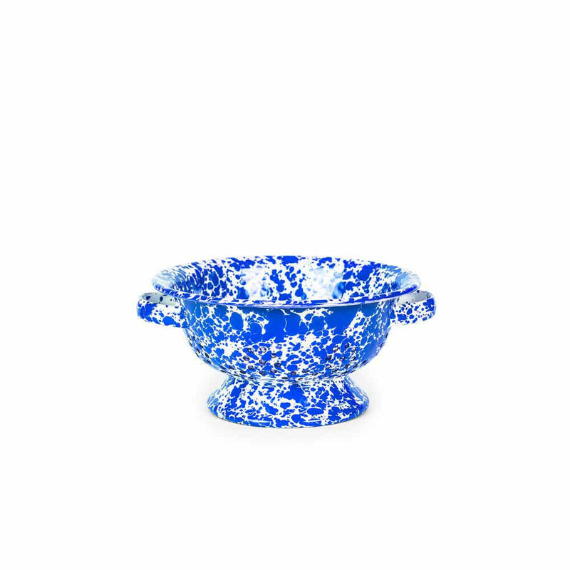 Crow Canyon Home's Splatter Enamelware Small Berry Colander in blue splatter design, ideal for quick rinses, combining charm and practicality for any kitchen.