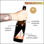 Three Spirit Blurred Vines Spark bottle held by a tattooed arm, featuring New Look, Same Flavour! banner. Highlights guayusa, schisandra berry, and cayenne. World Alcohol-Free Awards 2023 seal.