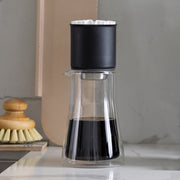 FELLOW | Stagg Pour-Over XF dripper on a glass carafe, showcasing its flat-bottom design for steady, consistent brewing.