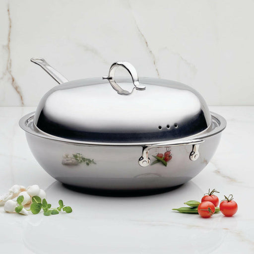 Hestan Provisions | Stainless Steel Lids - Dome - 14 on countertop with herbs and vegetables, illustrating its use for enhancing cooking experiences.