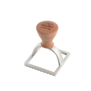 Marcato 3 Square Ravioli Stamp with wooden handle, ideal for crafting authentic, evenly-sized ravioli, enhancing homemade pasta experiences from Athens Cooks.