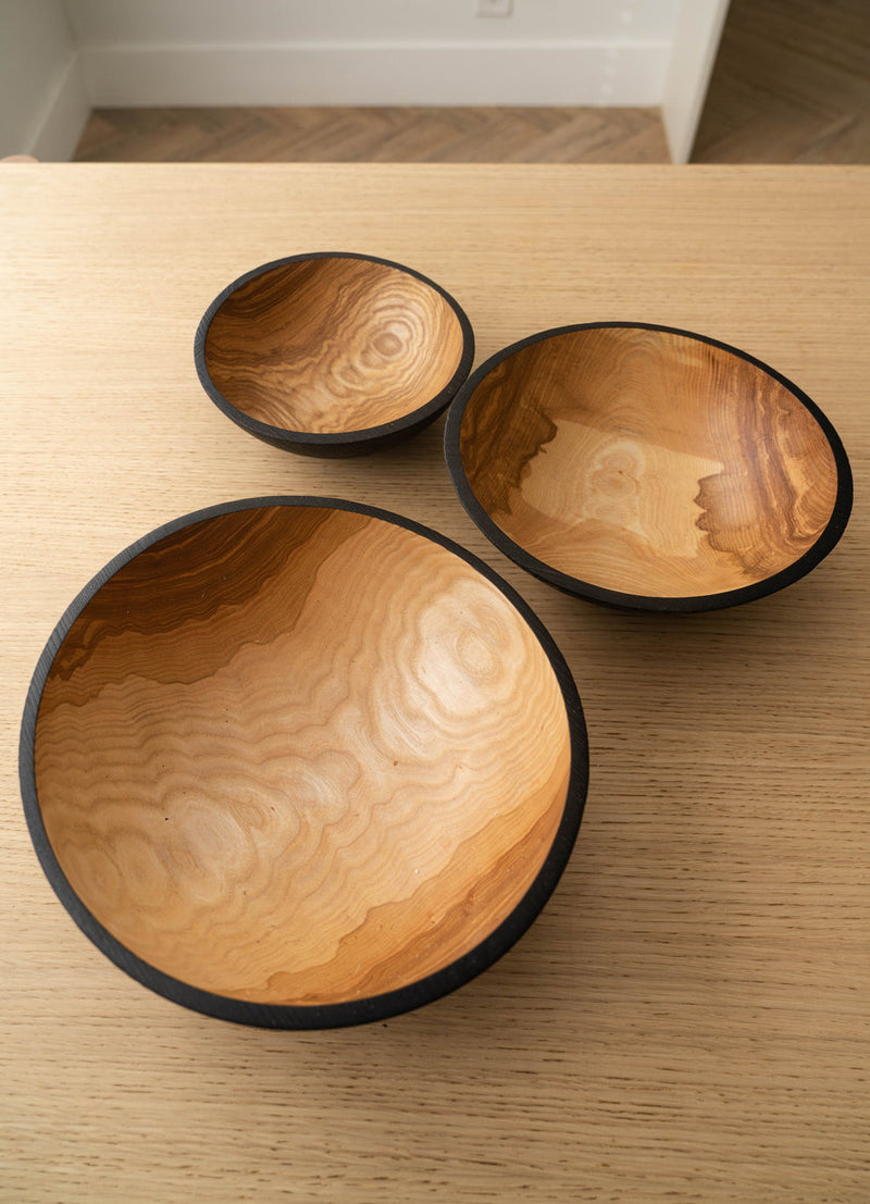 Creating Comfort Lab | Handmade Ukrainian Charred Wooden Salad Bowls, Small; three hand-carved nesting bowls with dark rims and rich grain patterns, ideal for serving or display.