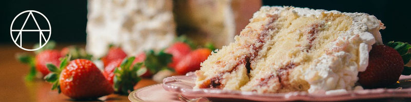 Summertime Strawberry Shortcake on a plate, featuring layers of white frosting and strawberries, representing the culinary expertise of Athens Cooks.