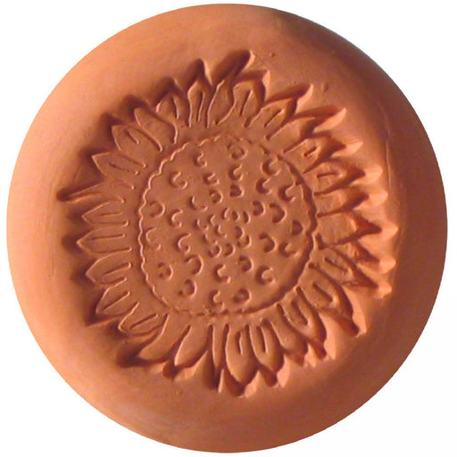 Close-up of a clay Sugar Saver - Maple Leaf with a carved flower pattern, designed to keep brown sugar soft by soaking in water.