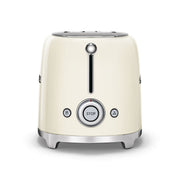 Smeg | 2 Slice Toaster - Cream, featuring dual slots, chrome trim, lever, and buttons for stop, defrost, and reheat. Compact design for versatile toasting.