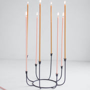 The Floral Society | Long Stem Beeswax Candles, Ochre, in a black iron candelabrum, ideal for intimate gatherings, showcasing minimalist elegance and smoke-free, natural beeswax craftsmanship.