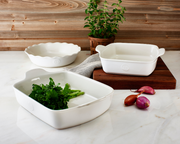 Emile Henry | Modern Classics Mini Pie Dish, showcased with fresh greens and onions, epitomizing personal pie-baking with HR ceramic for perfect results, embodying Athens Cooks' commitment to quality cookware.
