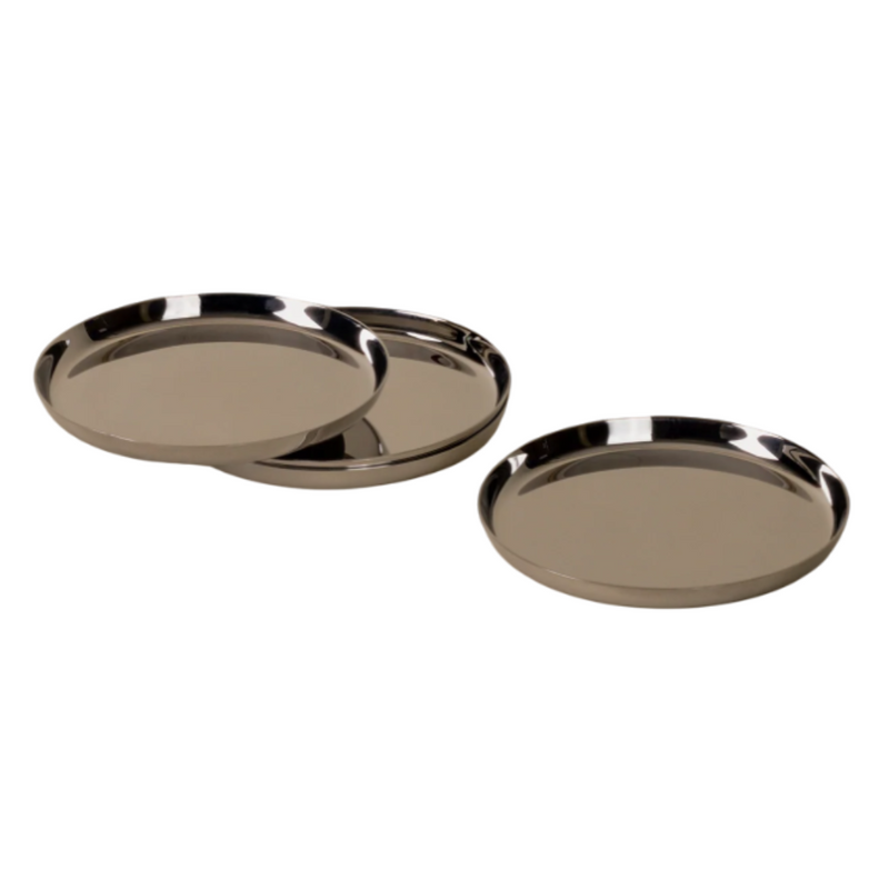 Holcomb Studio | Puddle Coasters, Set of Four: Round silver stainless steel coasters with anti-slip pads, designed to protect surfaces from condensation and fit neatly when stacked.