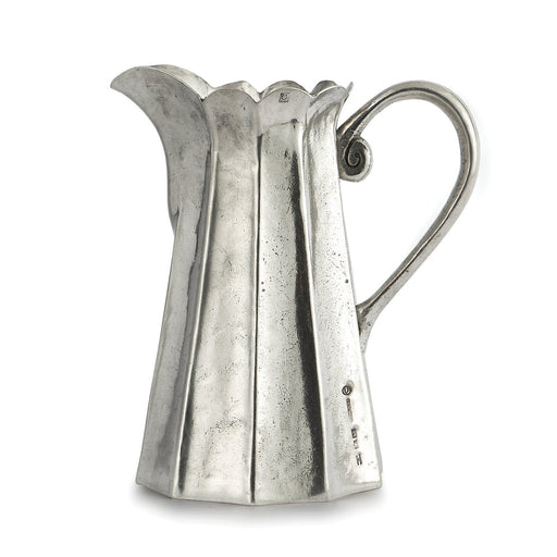 Arte Italica & Crown Linen Designs | Vintage Tall Scalloped Pitcher: A handcrafted Italian pewter pitcher with a faceted design, scalloped rim, and curved handle, perfect for elegant table service.